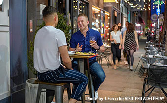 gay couple dining outdoors in midtown village