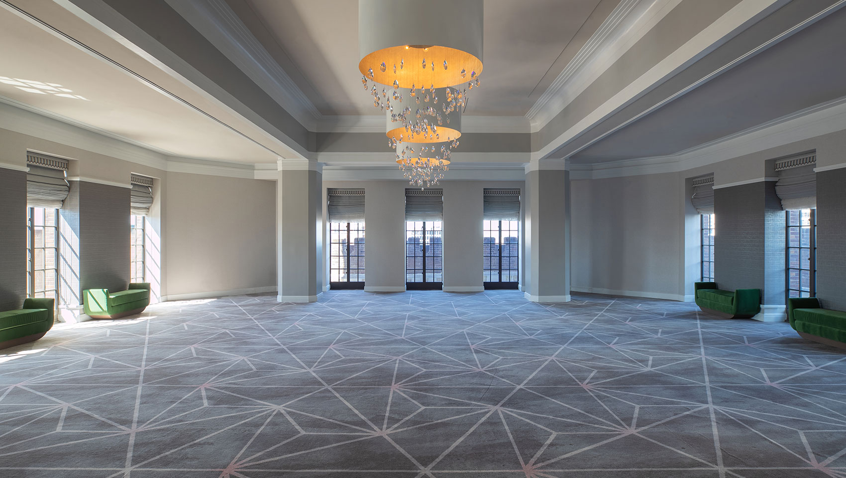 Empty Burnham Ballroom venue space with tall windows at the far ends of the room on every wall that overlook city