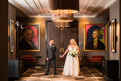 bride and groom embracing in front of a reception table