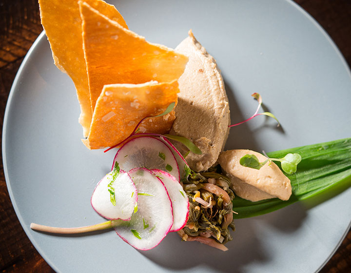 Mushroom Pate plated on dish resting on top of wooden tabletop