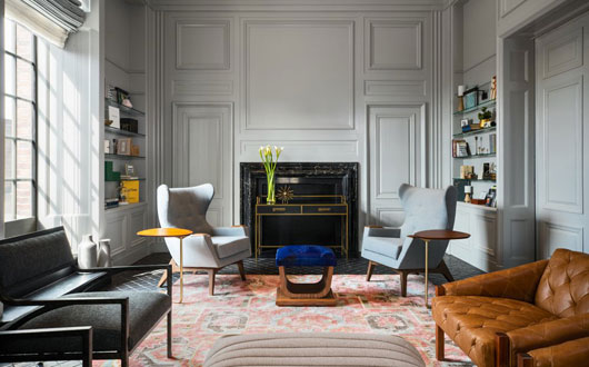 Kimpton Hotel Palomar Philadelphia's AIA Library with seating, bookshelves, and fireplace